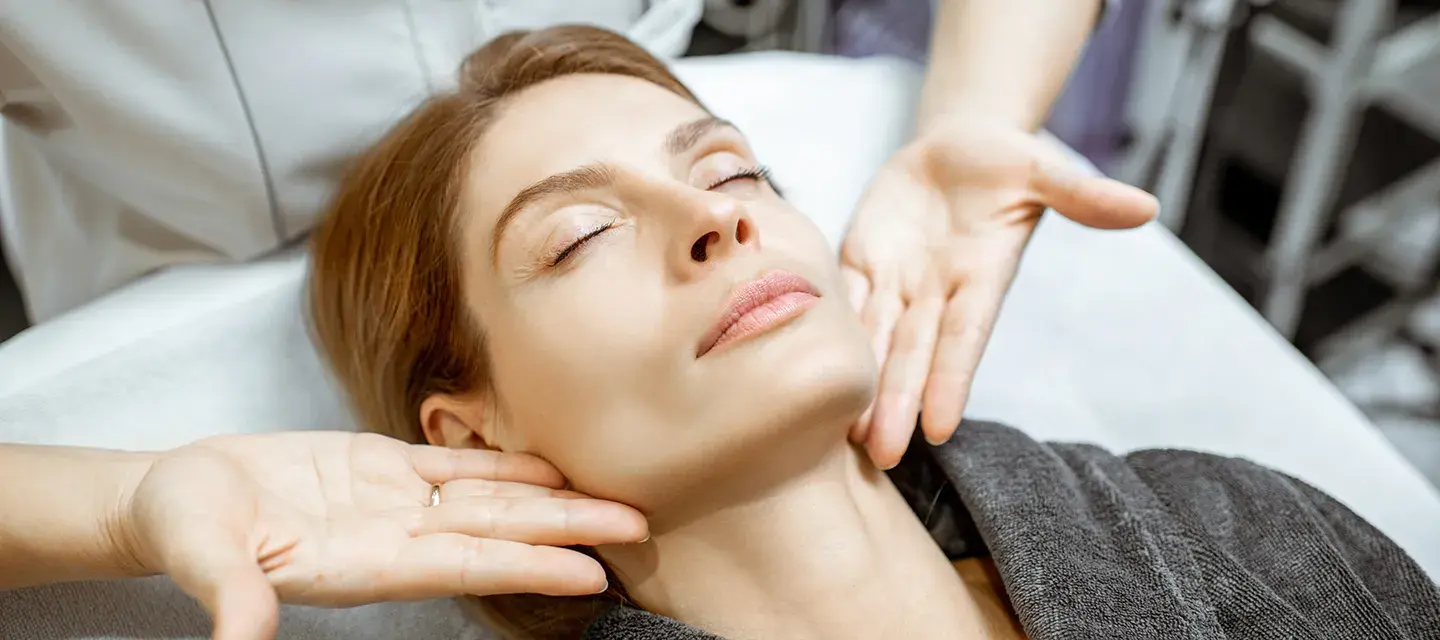 A woman getting a lymphatic drainage massage on face